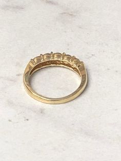 a gold ring sitting on top of a white counter