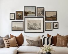 a living room filled with lots of furniture and pictures on the wall above it's couch