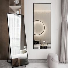 a large mirror sitting in the middle of a room next to a chair and table