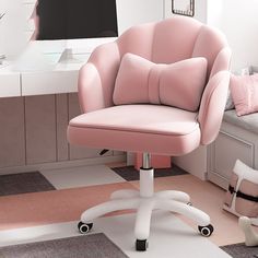 a pink office chair sitting in front of a desk with a computer monitor on it