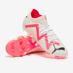 a pair of white and pink soccer shoes