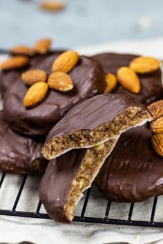 chocolate covered cookies with almonds and nuts on a cooling rack for gluten