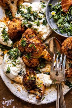 a white plate topped with cauliflower and other food