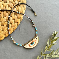 🌟 Designed for those who like to be original and looking for unique jewelry  ✅ Each piece is hand-shaped and drawn by us, making it wonderfully unique--so, expect a bit of delightful variation from the pictures 🍀 Because of their handmade charm, every ceramic piece is entirely one-of-a-kind. These high-quality creations are made to last, just like the memories you'll create with them!  🎁 It is suitable for every day , it can also be purchased as a perfect gift for special days like Valentine's Day, Mother's Day, Christmas or Birthday gift 🧿 Turkish evil eye  The evil eye symbolizes protection from bad energy and envy in Turkish and Middle Eastern culture The evil eye bead is believed to bring good vibes and good luck, we hope it will give you the same feeling! 📦 Packing :  All necklac Handmade Symbolic Multicolor Jewelry, Unique Pendant Necklace For Souvenirs, Handmade Spiritual Jewelry For Souvenir, Bohemian Pendant Necklace For Souvenir, Bohemian Pendant Necklace As Souvenir, Handmade Spiritual Jewelry As Souvenir, Bohemian Pendant Necklace, Handmade Multicolor Jewelry As Souvenir, Handmade Multicolor Necklace Souvenir