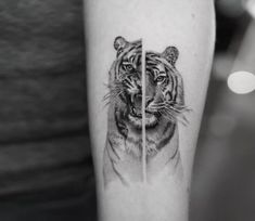 a black and white photo of a tiger on the left arm with an arrow in front of it