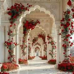 an archway covered in red flowers and greenery