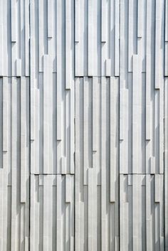 the side of a building with vertical lines on it