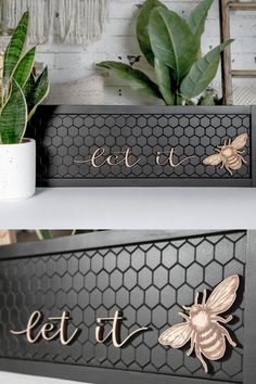 two black and gold bee plaques with the words let it bee on them, next to a potted plant