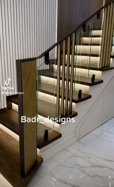 a staircase with glass railing and wooden handrails in a modern home interior design