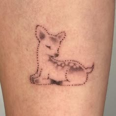 a small tattoo on the leg of a woman with a dog in it's stomach