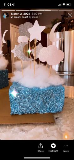 there is a cake with stars and clouds on it in the shape of a box