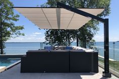 an outdoor living area next to the water