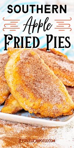 two fried breaded pastries on a white plate with powdered sugar over them