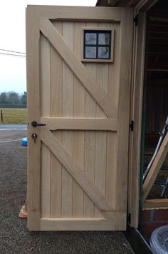 an open wooden door on the side of a building