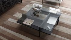 a glass coffee table sitting on top of a wooden floor