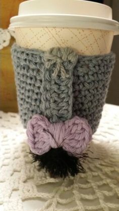 a coffee cup with a knitted bow on it