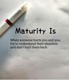 a pen sitting on top of a piece of paper with the words maturity is