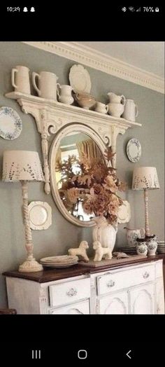 a white dresser sitting next to a mirror on top of a wall