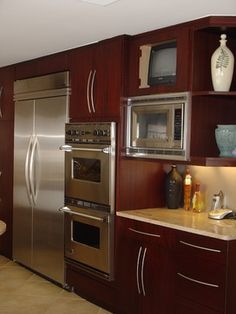 a kitchen with stainless steel appliances and wooden cabinets