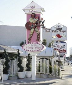 a giant elvis presley sign on the side of a building in front of a restaurant