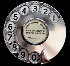 an old style rotary telephone with numbers on the dial and two hands that are not working