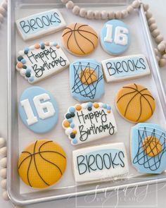 decorated cookies in the shape of basketballs and sports related items are on a tray