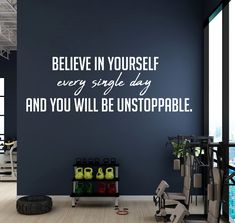 a gym room with exercise equipment and motivational wall stickers on the walls that say, believe in yourself every single day and you will be unstoappable