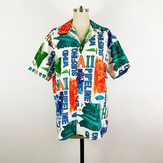 "What an exquisite example of 1960's tiki surfer Hawaiian shirts. Bold and bright crisp cotton batik pattern, rainbow of colors of surfing and windsurfing on a white background. Traditional Hawaiian shirt style with a more boxy silhouette, unlined and made by Rai Nani Hawaii. Wonderful vintage condition, some very faint yellowing and a few marks all from storage, these flaws are unseen when worn, very crisp feels unworn/washed. Measurements Estimated Modern size: Men Size: Large Women's Size: Ex Multicolor Hawaiian Camp Shirt In Cotton, Casual Multicolor Cotton Hawaiian Shirt, Cotton Shirt With Camp Collar In Multicolor Print, Casual Patterned Shirt With Bold Print, Multicolor Relaxed Fit Hawaiian Shirt In Cotton, Multicolor Relaxed Fit Cotton Hawaiian Shirt, Multicolor Cotton Hawaiian Shirt With Relaxed Fit, Retro Multicolor Print Collared Top, Cotton Tops With Retro Print And Camp Collar