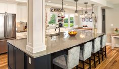 a large kitchen with an island in the middle and lots of counter space on one side