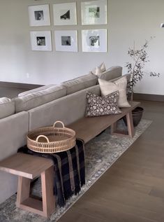 a living room filled with furniture and pictures hanging on the wall above it's couch