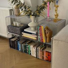 a living room filled with lots of books and vases on top of each other