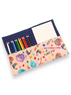 a pencil case filled with lots of different colored pens and paper next to each other