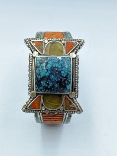 The Beautiful Hand Made Vintage Nepali Tibetan Silver Bracelet Decorated Beautifully With Coral and Turquoise With Unique Historic Patterns Designs . Conditions Of Items Is Clearly Shown In The Pictures Above Fast and Free Shipping World Wide Bohemian Blue Cuff Bracelet With Natural Stones, Traditional Blue Bracelets With Natural Stones, Blue Bohemian Cuff Bracelet With Natural Stones, Bohemian Multicolor Rectangular Jewelry, Traditional Blue Gemstone Bracelets, Unique Turquoise Bracelets For Festival, Bohemian Multi-stone Cuff Bracelet As Gift, Bohemian Multicolor Gemstone Cuff Bracelet, Bohemian Multi-stone Adjustable Bracelets