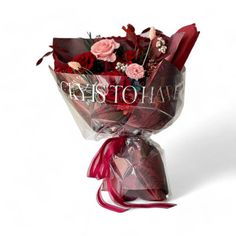 a bouquet of red roses wrapped in cellophane