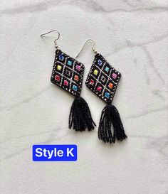 The perfect boho piece of jewelry for any look! These embroidered cloth kite earrings are handmade by artisans in Chiapas, Mexico. Each earring is about 3 inches long, extremely light, and come with an plastic earring back. Please select your choice of color at checkout. All items are made with love by talented skilled artisans. Because of the handmade nature of the items, they may have some imperfections. However, this is what makes them one of a kind! Bohemian Beaded Embroidered Earrings For Festivals, Bohemian Embroidered Earrings For Festive Occasions, Multicolor Embroidered Bohemian Earrings, Bohemian Embroidered Festive Earrings, Black Bohemian Woven Jewelry, Black Woven Bohemian Jewelry, Traditional Woven Multicolor Earrings, Bohemian Woven Drop Earrings, Traditional Multicolor Woven Earrings