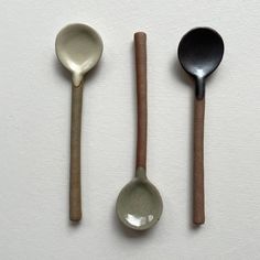 three spoons are lined up next to each other