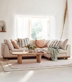 a living room filled with furniture and a rug on top of a wooden coffee table