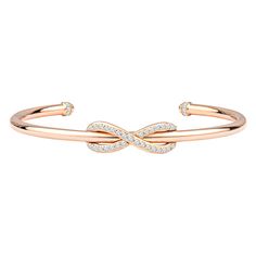 This classic Tiffany & Co. Diamond Infinity Cuff is a sleek, modern, 18kt rose gold piece with 0.39ctw in round diamonds encrusting the infinity symbol and topping the ends of the cuff. The diamonds are of D-F color, VS-VVS quality. The bracelet is a size medium, which fits up to about a size 6.5. This bracelet is brand new, and comes with the box and pouch. MSRP is $4750. Hallmark states T & Co. AU 750 Italy. Tiffany Bangle, Rose Gold Cuff Bracelet, Diamond Cuff Bracelet, Diamond Bracelet Design, Tiffany Bracelets, Rose Gold Bangle, Modern Bracelets, Gold For Sale, Diamond Bangles Bracelet