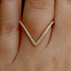 a woman's hand with a diamond ring on it