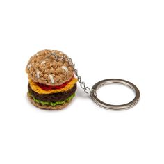 a crocheted hamburger keychain is shown with a metal ring on it