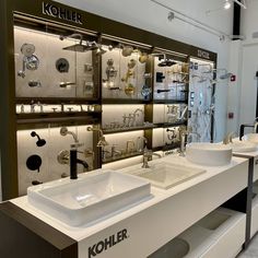 two sinks are shown in front of a wall with many different types of faucets