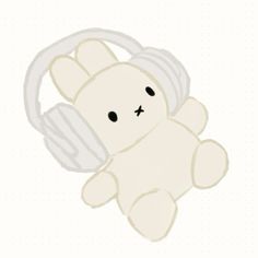 a white teddy bear with headphones on it's face and ears is laying down