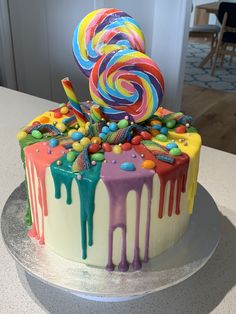 there is a cake decorated with candy and lollipops