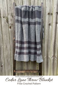 a gray and black plaid blanket hanging on a wooden chair with text overlay that reads, cedar lane throw blanket free croche pattern