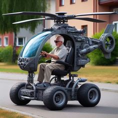 a man sitting in a small helicopter on wheels