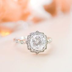 a close up of a diamond ring on a table