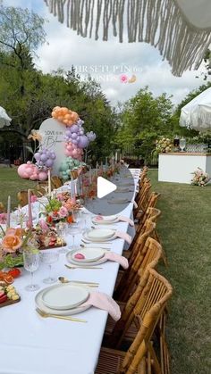 a long table set up with plates and place settings for an outdoor party or baby shower