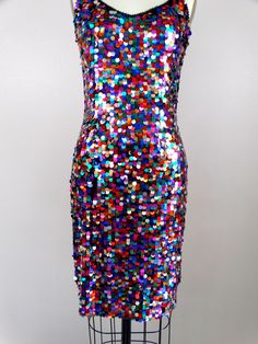 "This fun vintage party dress! It is fully embellished with rainbow paillette sequins and in excellent condition! Size SMALL Measurements: Bust - 32\" Waist - 26\" Hips - 36\" Length - 34\" Tag Size - 4 / Small (please refer to measurements) Size MEDIUM Measurements: Bust - 34\" Waist - 28\" Hips - 38\" Length - 33\" Tag Size - 6 /Medium (please refer to measurements) This dress comes from a pet-free and smoke-free home. If you would like more info or have any questions, please don't hesitate to Multicolor Contrast Sequin Party Dress, Glamorous Multicolor Sequin Cocktail Dress, Multicolor Contrast Sequin Dress For Party, Multicolor Sequin Dress For Party, Glamorous Multicolor Sequin Fabric For Party, Glamorous Multicolor Sequin Dress For Party Season, Multicolor Embellished Party Dress, Multicolor Sequined Disco Dresses, Disco Style Sequined Dress For Costume Party