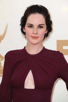 a woman in a red dress posing for the camera