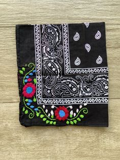 Mexican bandana Are you having a fiesta? Make sure to steal the show with this beautiful embroidered bandana. Wear it around your neck or hair. Perfect for those days at the beach. Each one is unique, if you want to see the ones in stock, please send us a message before placing your order 100% cotton. Size: 19 x 19 inches approx Care: cold water wash, hang to dry Hand embroidered in Mexico Please notice that the bandana is made in China, but all the embroidery is hand embroidered in Mexico by ta Black Bandana Print Gift Bandana, Bohemian Cotton Bandana Gift, Bohemian Cotton Bandana As Gift, Bohemian Cotton Bandana For The Beach, Black Bandana For Summer Beach Outings, Black Bandana For Summer Beach, Black Bandana For Beach And Summer, Traditional Cotton Bandana, Spring Beach Bandana Print Headscarf